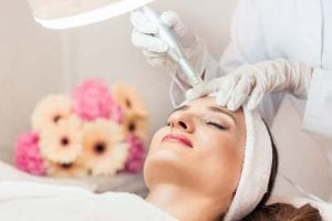 Close-up of the face of a woman relaxing during non-surgical facelift treatment in a contemporary beauty salon with innovative technology